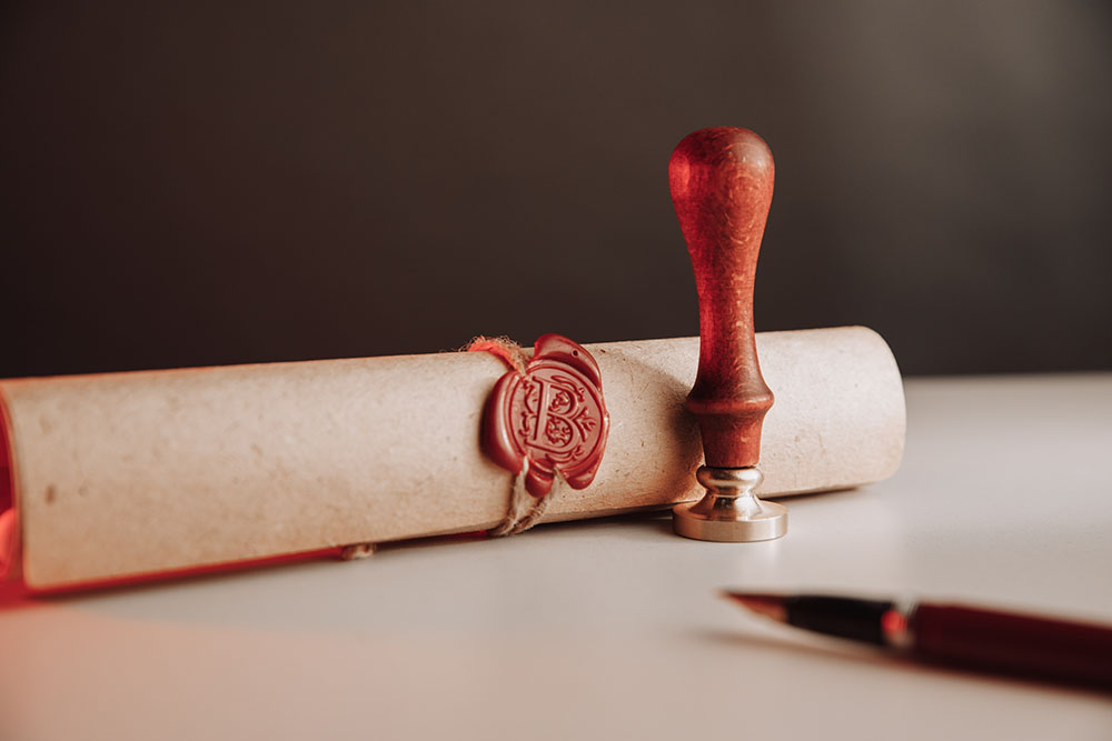 Scroll with wax seal stamp of notary public on a table