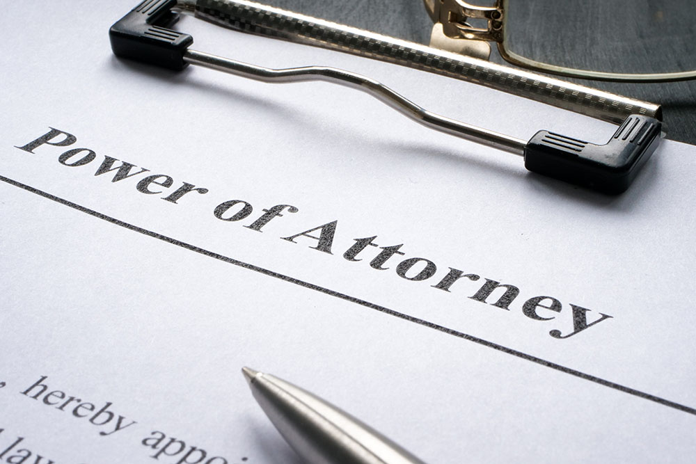 A Clipboard with Power of attorney and pen for signing.