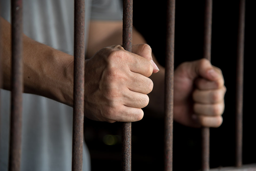 Hands of the prisoner in jail